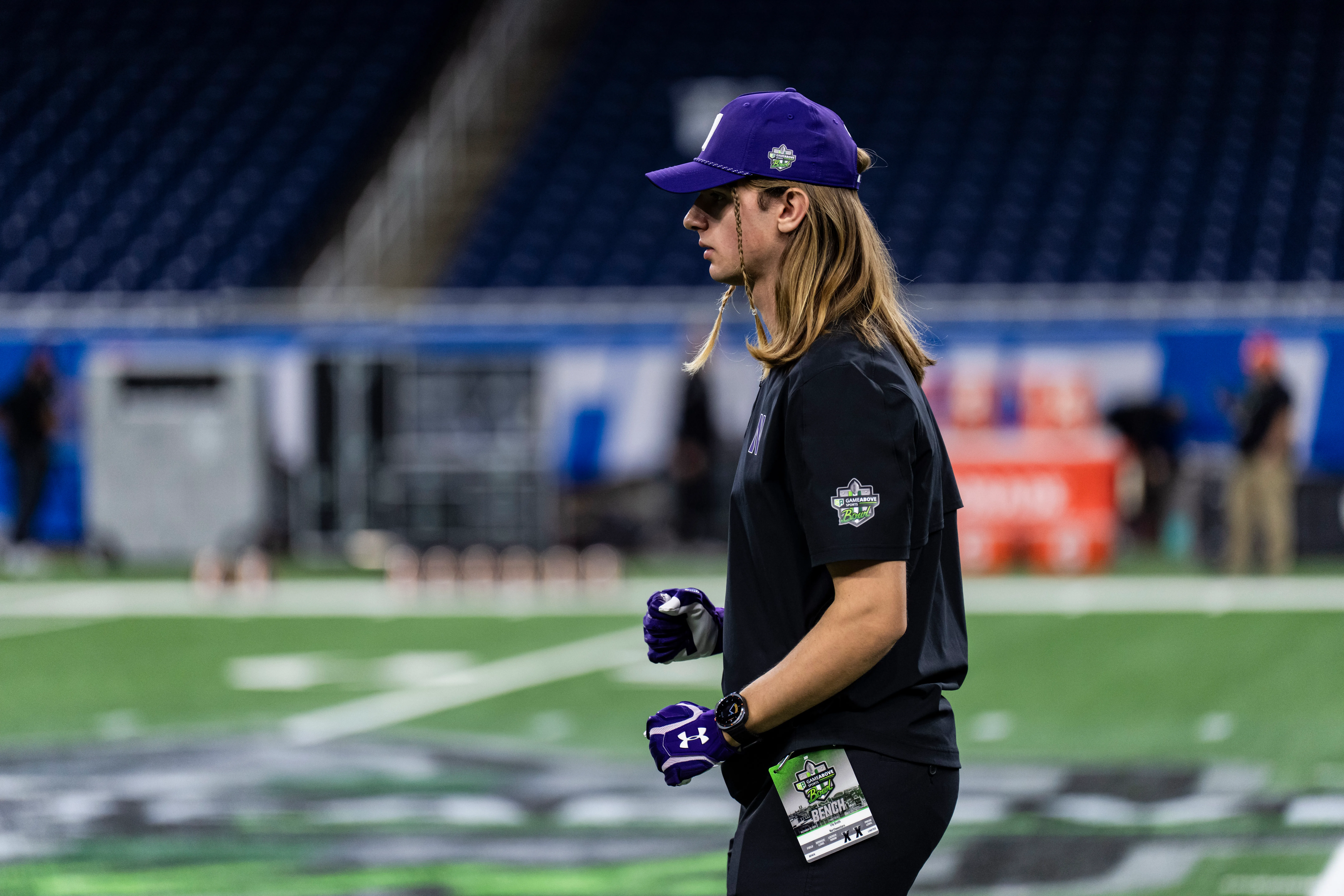 Lily Groth in Northwestern staff apparel, preparing to catch a football at the 2025 GameAbove Sports Bowl.